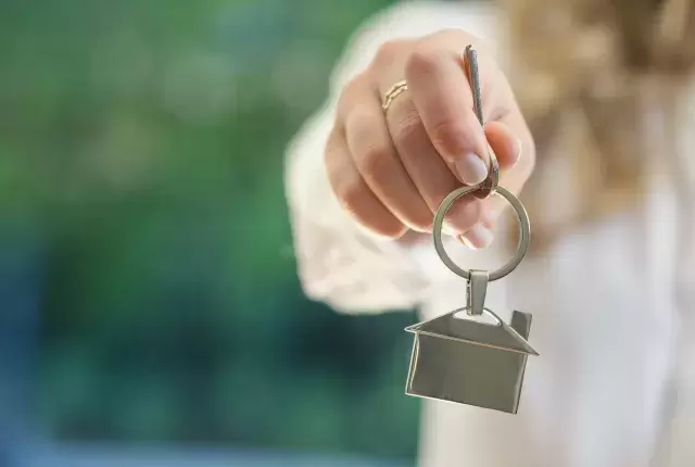 Estate agent dangling keys to new home