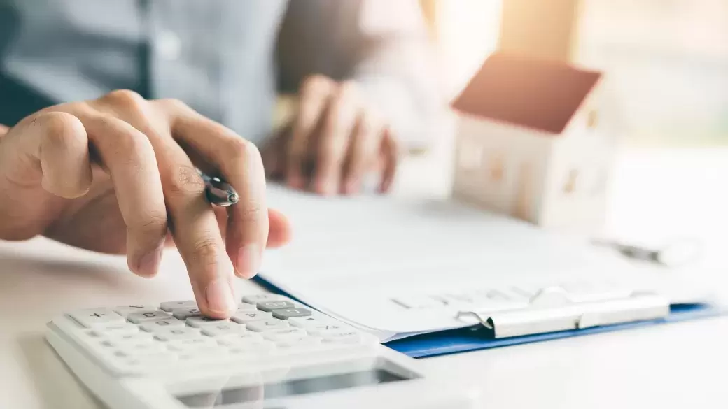 Housing developer using a calculator to calculate the cost of buying a new home.