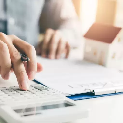 Housing developer using a calculator to calculate the cost of buying a new home.