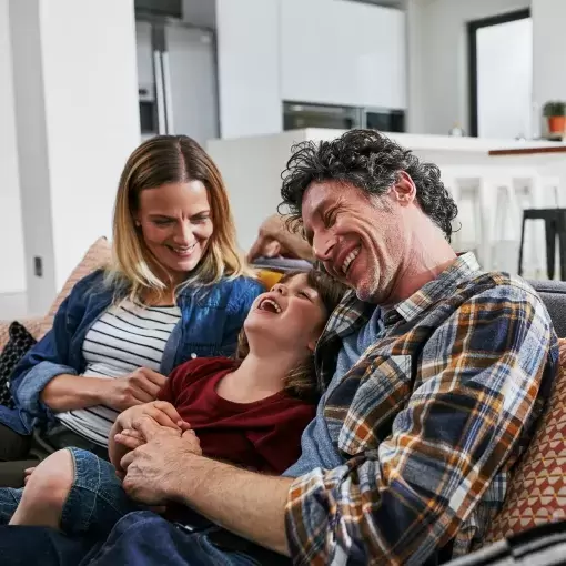 Cropped shot of an affectionate family of three relaxing on the sofa of their new home