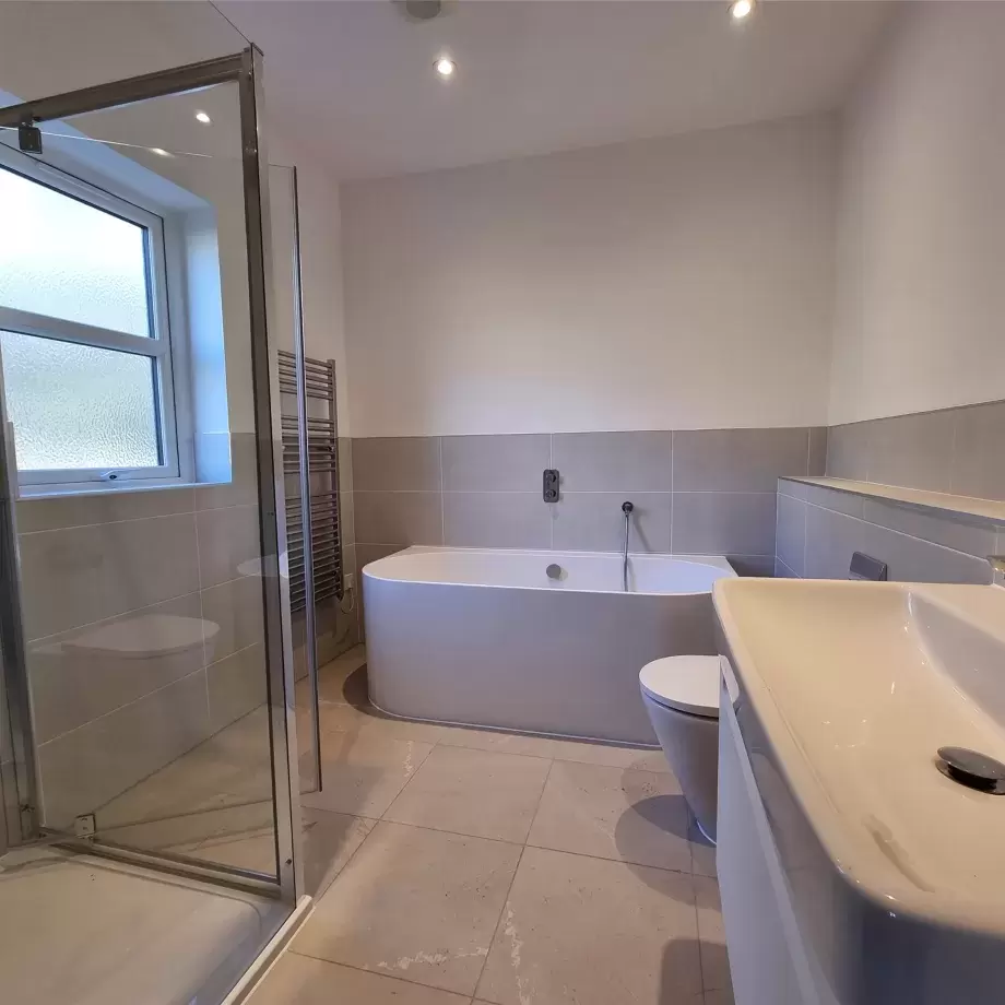 Large accessible ensuite bathroom with bath and separate shower